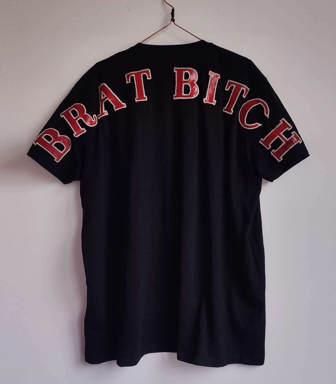 schwarzes T-Shirt mit großem, roten "Brat Bitch" Schriftzug auf der Rückseite