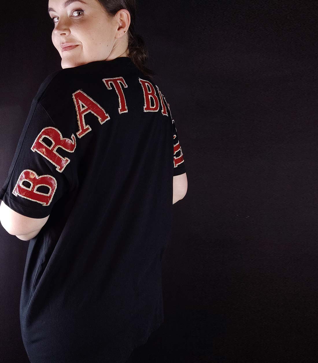 schwarzes T-Shirt mit großem, roten "Brat Bitch" Schriftzug auf der Rückseite